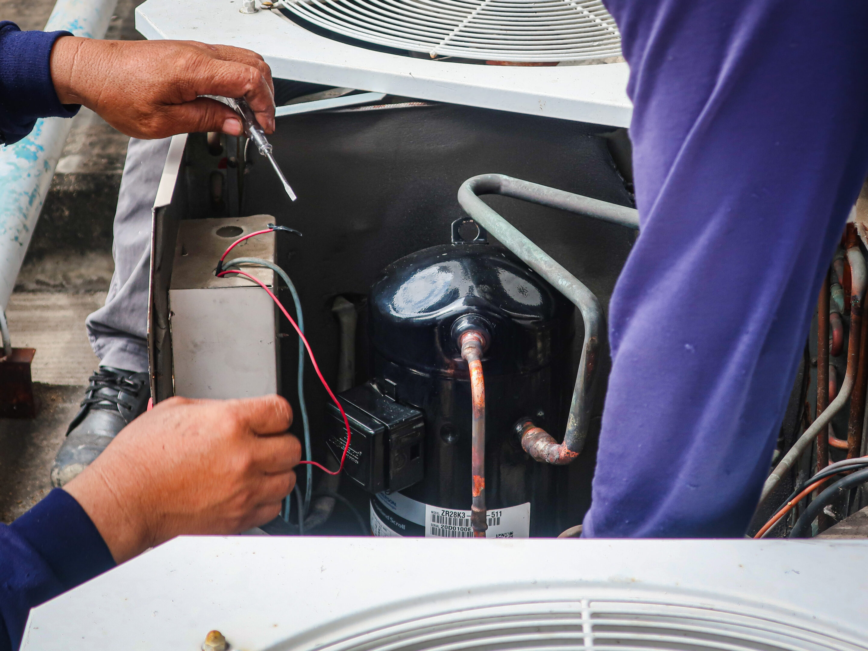 Men doing an a/c repair in Slidell, LA